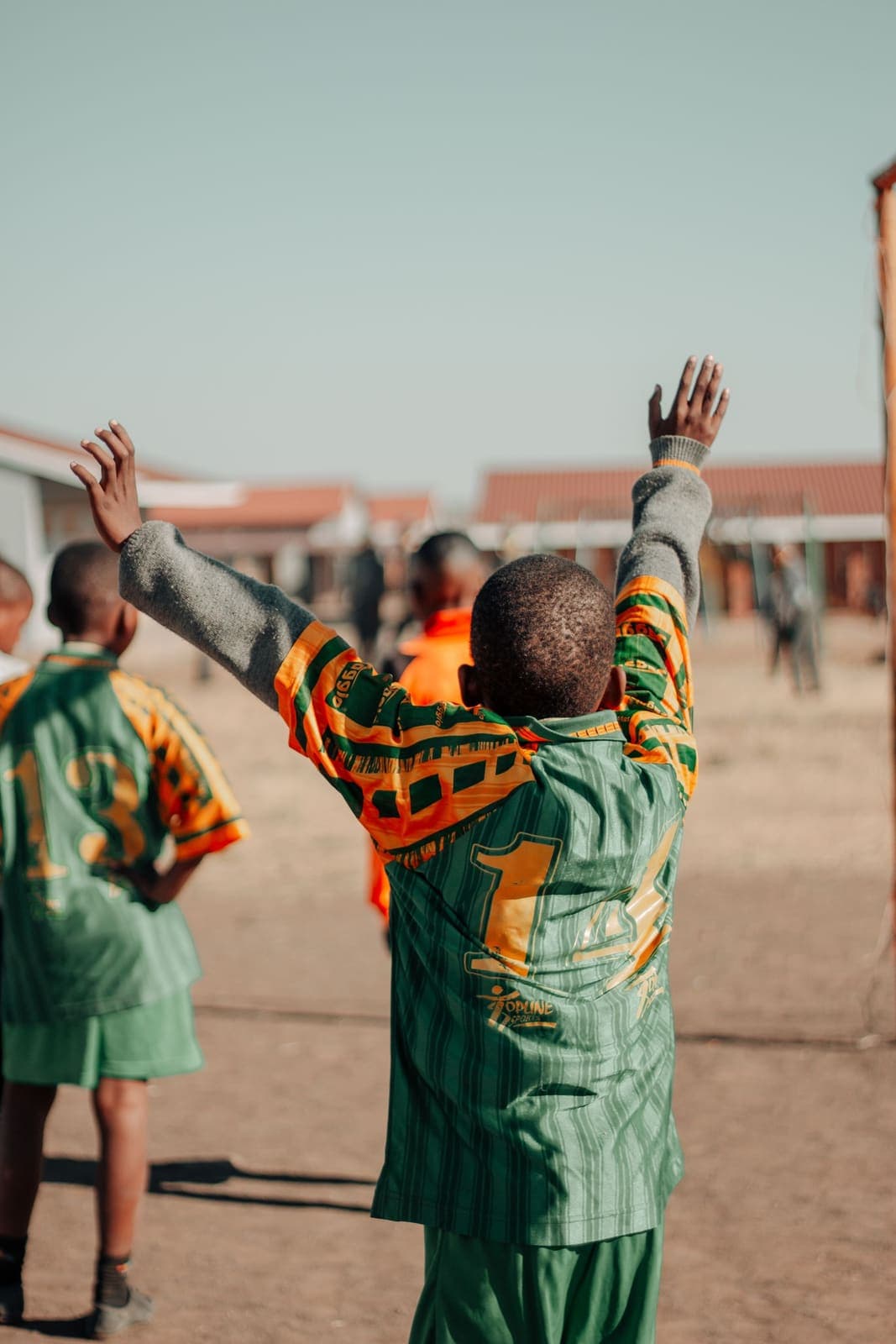 Children celebrating together during a school football match