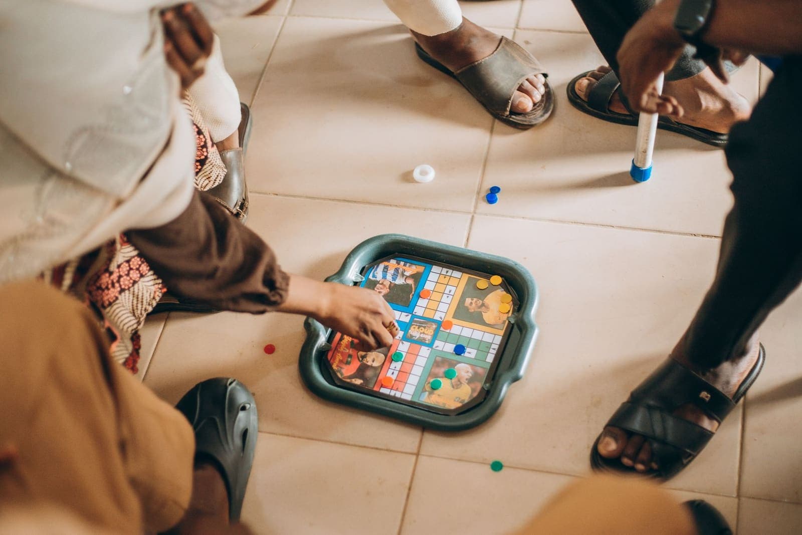 Children gathered around a board game on the floor
