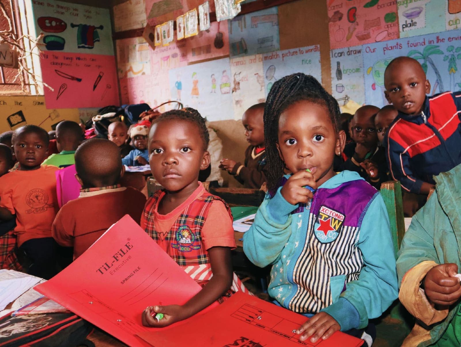 Pupils seated at desks in a colourful, well-lit classroom