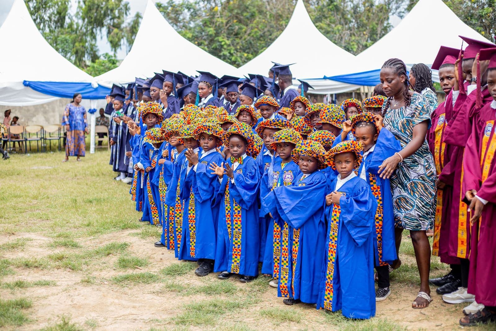 Pupils in ceremonial gowns lined up for a school celebration in Ghana